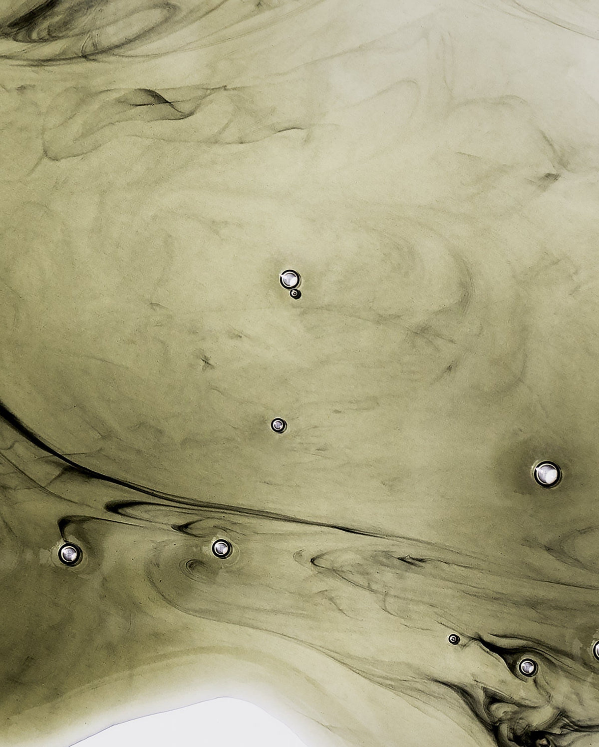 Bambu Earth Activated Charcoal Cleansing Oil - Abstract pattern of black and gray swirling on a beige background