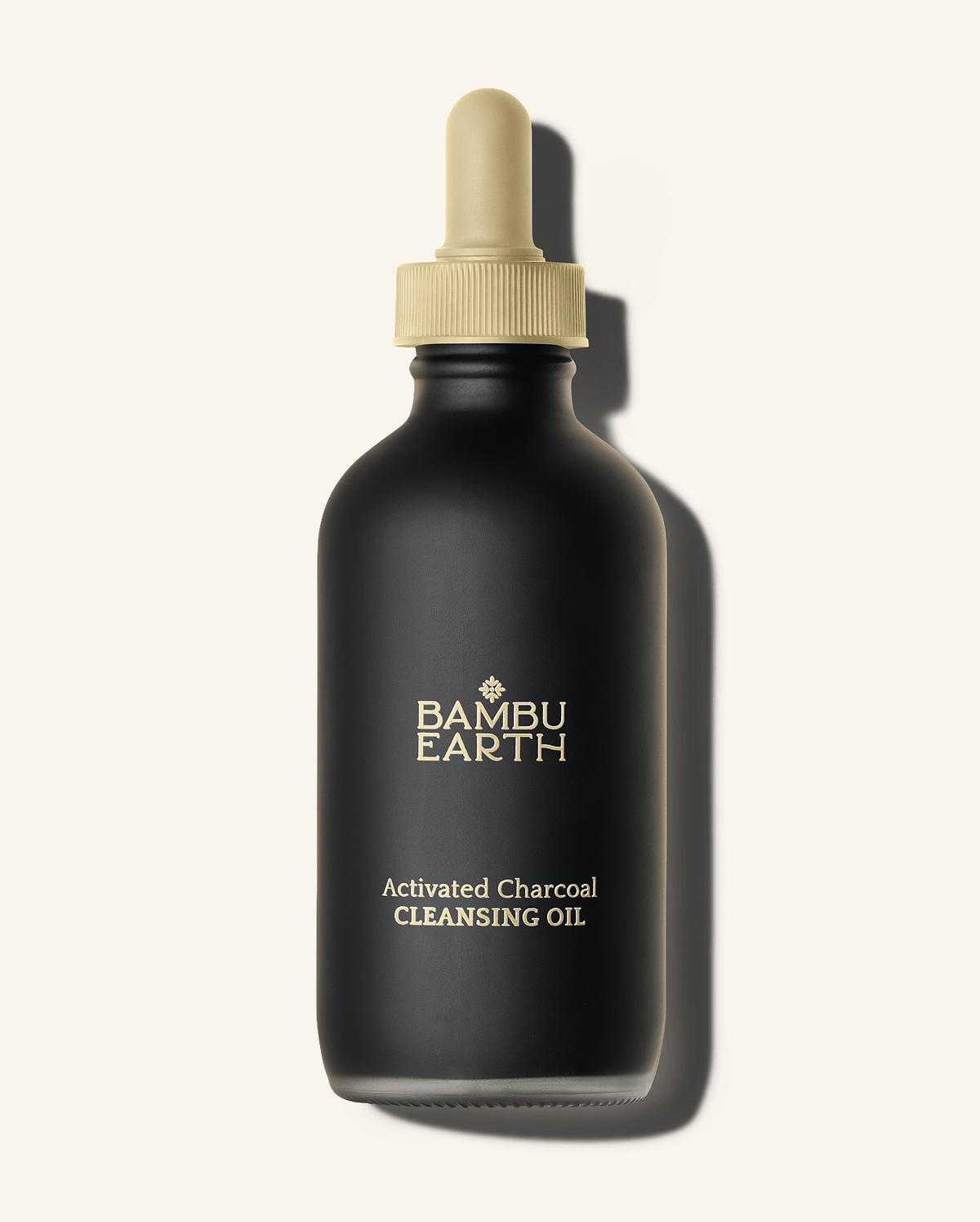 Bambu Earth Activated Charcoal Cleansing Oil - Black bottle of Bambu Earth Activated Charcoal Cleansing Oil with a beige