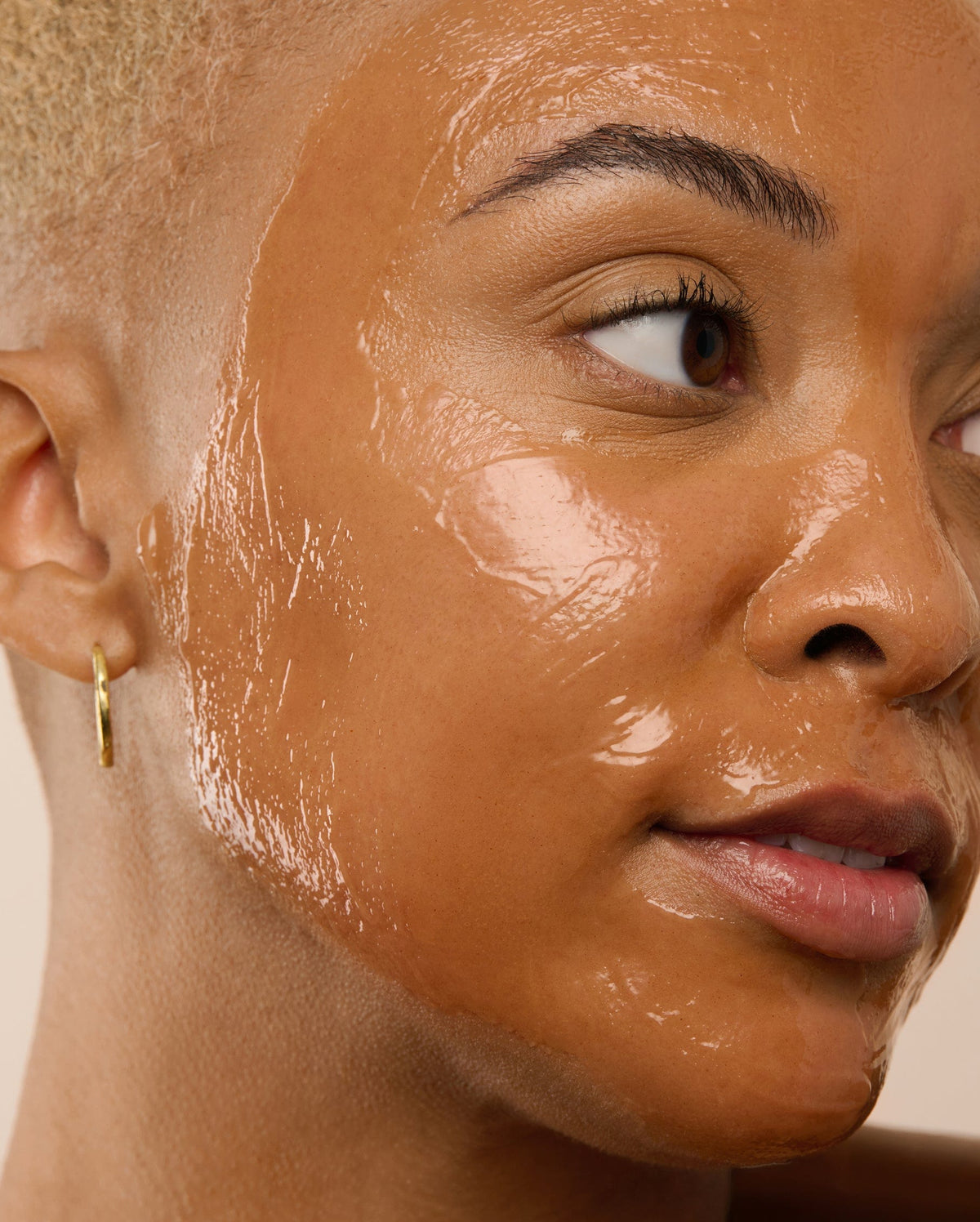 Bambu Earth Papaya Enzyme Exfoliating Mask - Close-up of a person with a brown face mask applied to their face.