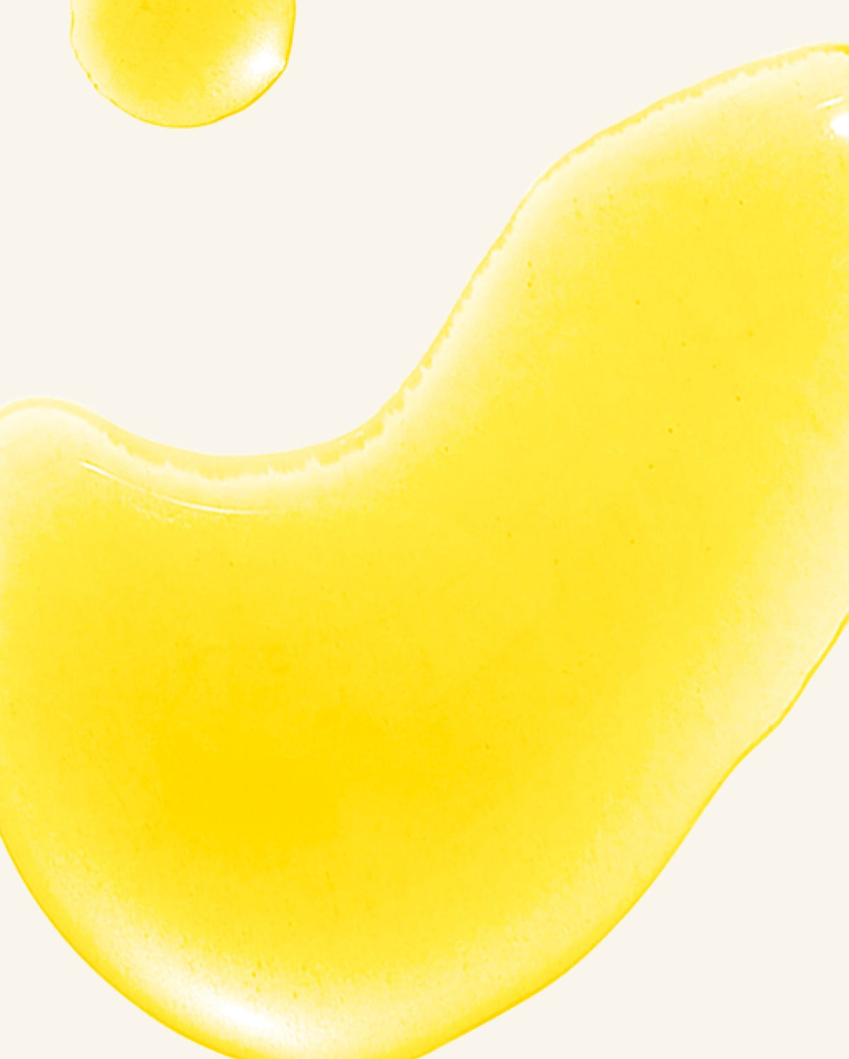 Bambu Earth Rosehip Repairing Facial Serum - Close-up of yellow paint or cream on a white background